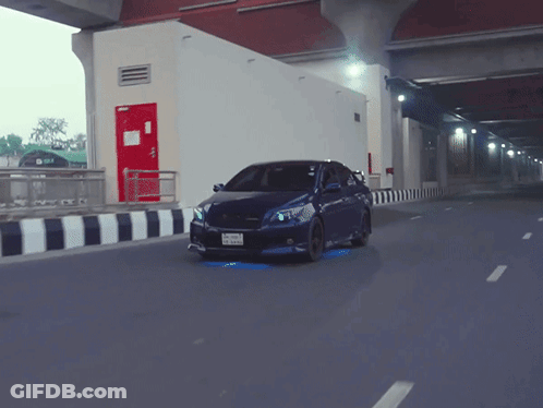 A Blue Car With A License Plate That Says ' A ' On It Is Driving Down A Road GIF