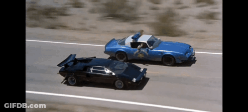 A Blue Car With A Sheriff 'S Badge On It GIF