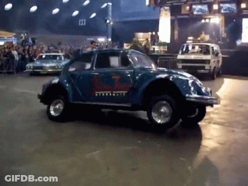 A Blue Car With A Sticker On The Side That Says Volkswagen GIF