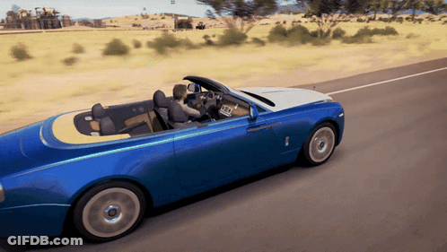 A Blue Car With A Yellow Top Is Driving Down A Road GIF