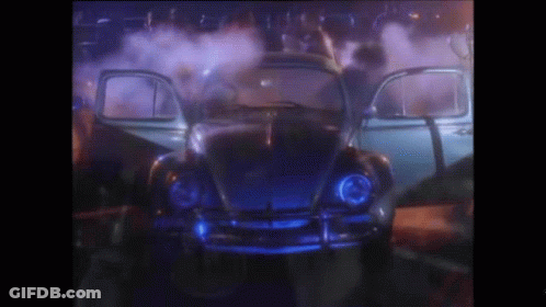 A Blue Car With The Doors Open Is Surrounded By Smoke GIF