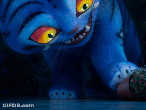 A Blue Cartoon Cat With Yellow Eyes Is Looking At Something GIF