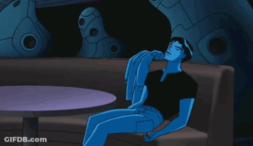 A Blue Cartoon Character Is Sitting On A Couch With A Table In The Background GIF
