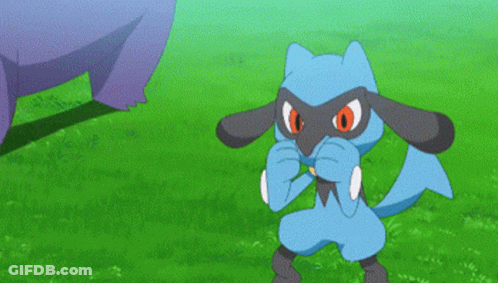 A Blue Cartoon Character With Red Eyes Is Standing In A Grassy Field GIF