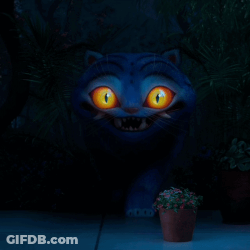 A Blue Cat With Yellow Eyes And Sharp Teeth Is Walking In The Dark GIF