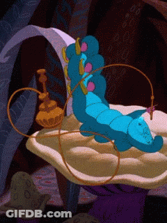 A Blue Caterpillar From Alice In Wonderland Is Laying On A Cushion GIF