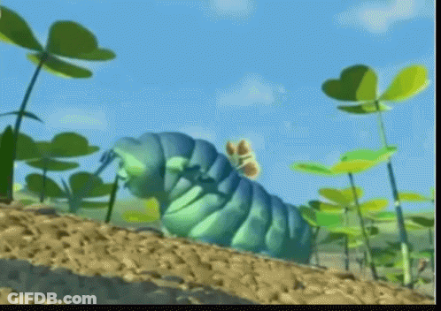 A Blue Caterpillar With A Butterfly On Its Back Is Crawling Through A Field Of Plants GIF