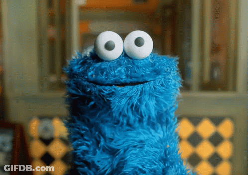 A Blue Cookie Monster With White Eyes Is Smiling GIF