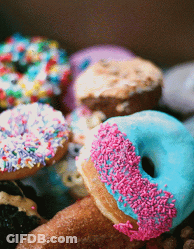 A Blue Donut With Pink Sprinkles On It GIF