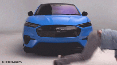 A Blue Ford Mustang With A Black Horse On The Front GIF
