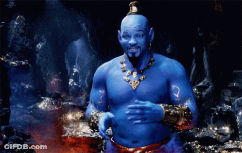 A Blue Genie With A Beard And A Necklace Is Standing In A Cave GIF