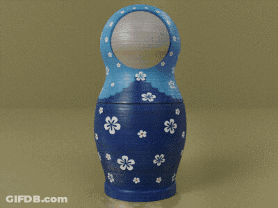 A Blue Green And Orange Russian Nesting Doll With White Flowers On Them GIF