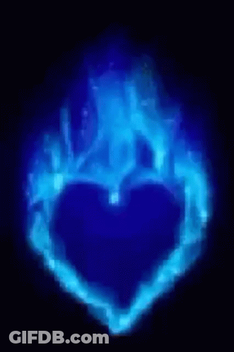 A Blue Heart Is Surrounded By Blue Flames On A Dark Background . GIF