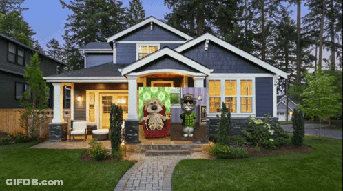 A Blue House With Two Stuffed Animals In Front GIF