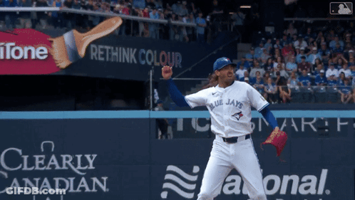 A Blue Jays Pitcher Throws A Pitch In Front Of An Ad For Rethink Colour GIF