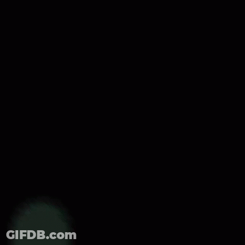 A Blue Light Is Shining Through A Dark Background GIF