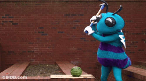 A Blue Mascot Is Cutting A Watermelon With A Hammer GIF