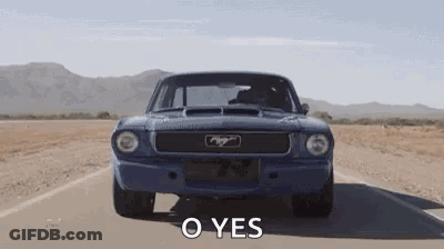 A Blue Mustang Is Driving Down A Desert Road With The Words `` O Yes '' Written On It . GIF