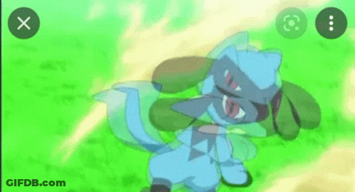 A Blue Pokemon With Red Eyes Is Standing In The Grass And Looking At The Camera . GIF