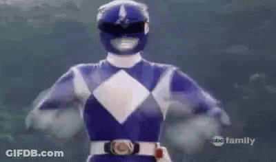 A Blue Power Ranger Is Flying Through The Air With His Arms In The Air . GIF
