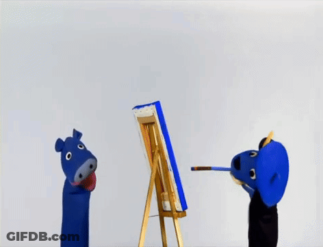 A Blue Puppet Is Painting A Picture On An Easel GIF