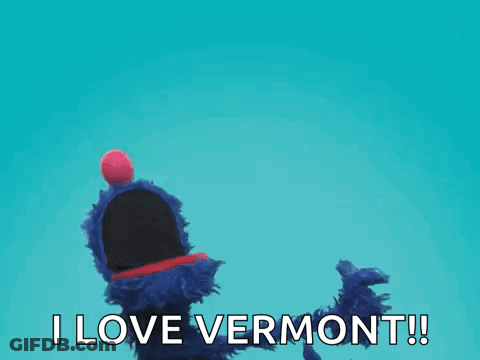 A Blue Puppet With A Red Ball On Its Head Is Saying I Love Vermont ! GIF