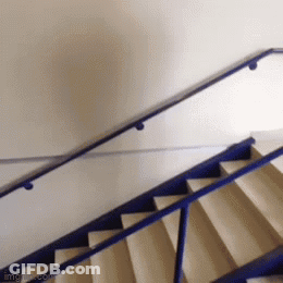 A Blue Railing On A Set Of Stairs With A White Wall GIF