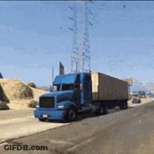 A Blue Semi Truck Is Driving Down A Highway GIF