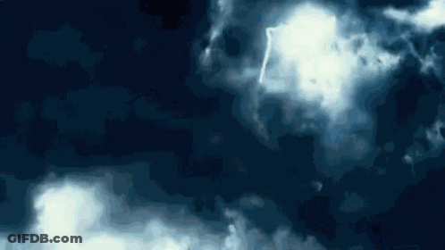 A Blue Sky With White Clouds And A Lightning Strike GIF