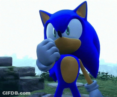 A Blue Sonic The Hedgehog Is Standing In A Grassy Area GIF