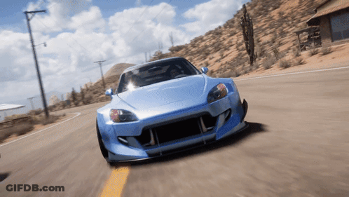 A Blue Sports Car Is Driving Down A Road In The Desert GIF