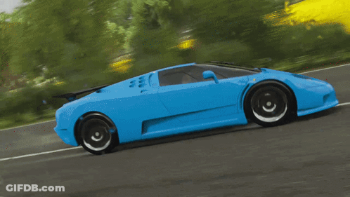 A Blue Sports Car Is Driving Down A Road Next To A Yellow Wall GIF