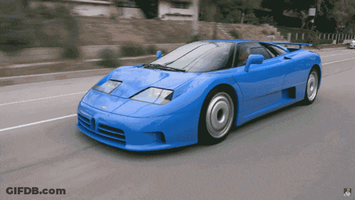 A Blue Sports Car Is Driving Down A Street With A Sign That Says No Parking GIF