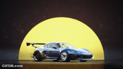 A Blue Sports Car Is Parked In Front Of A Yellow Light GIF