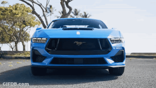 A Blue Sports Car With A Horse On The Front GIF