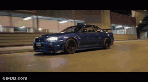 A Blue Sports Car With A License Plate That Says ' Nz ' On It GIF