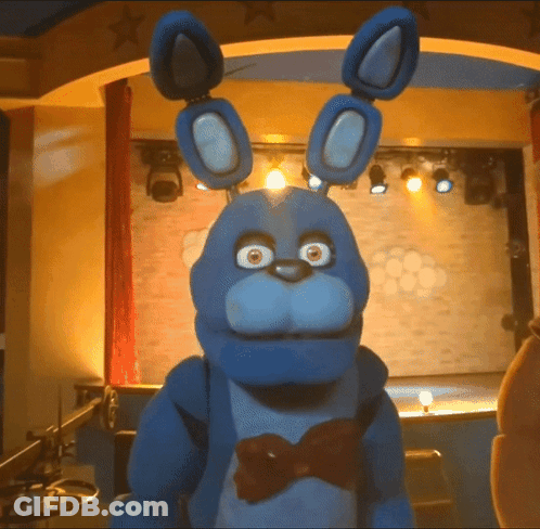 Blue Stuffed Animal With Bow Tie On Stage GIF