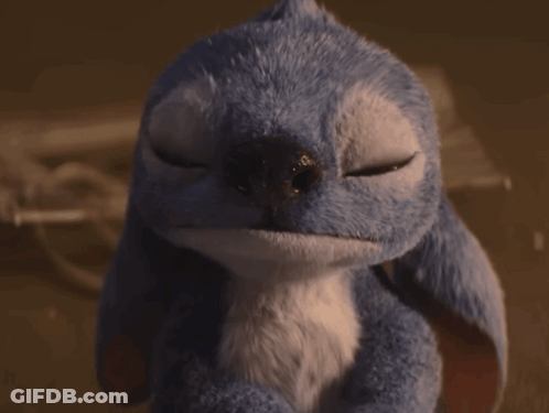 A Blue Stuffed Animal With Its Eyes Closed Looks Like A Bird GIF