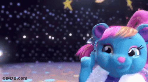A Blue Stuffed Animal With Pink Hair Is Standing On A Stage GIF