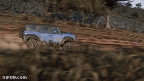 A Blue Suv Is Driving On A Dirt Road GIF