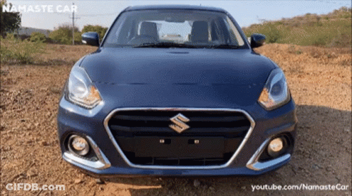 A Blue Suzuki Car Is Parked On A Dirt Field GIF