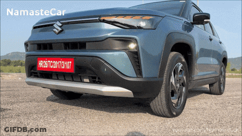 A Blue Suzuki Car With A License Plate That Says Hr26tc20173107 GIF