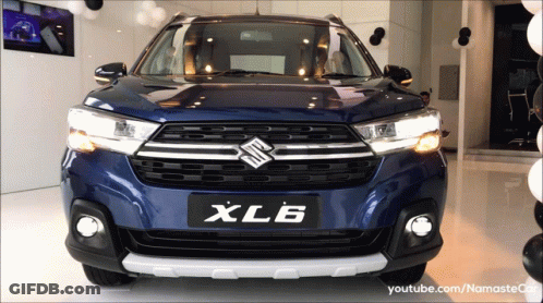 A Blue Suzuki Xl6 Is On Display At A Dealership GIF