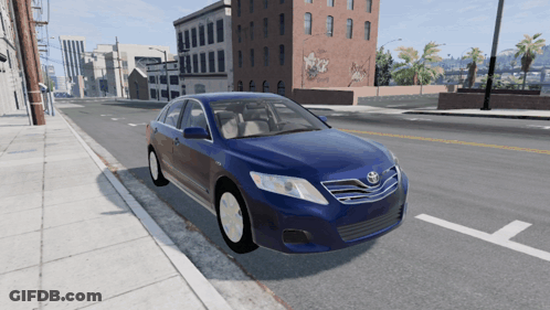 A Blue Toyota Car Is Parked On The Side Of The Street GIF