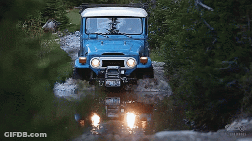 A Blue Toyota Jeep Driving Through A River GIF