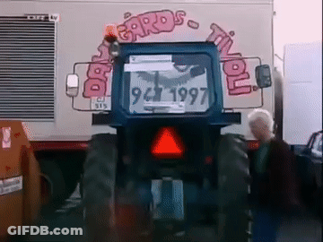 Blue Tractor Parked In Front Of Cards Til You Sign GIF