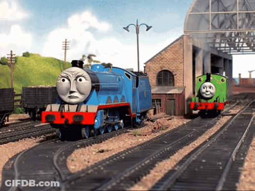 A Blue Train With The Number 1 On It Is On The Tracks GIF