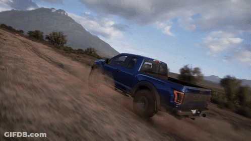 A Blue Truck Is Driving Down A Dirt Hill GIF