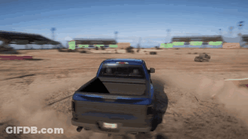 A Blue Truck Is Driving Through A Dirt Field With A California License Plate GIF