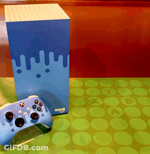 A Blue Xbox Controller Sits On A Table Next To A Box That Says Ihop GIF